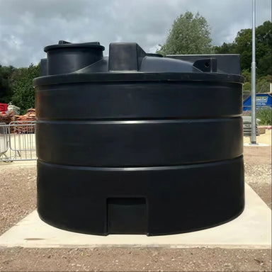 Side view of a 10,000 litre above-ground rainwater harvesting system in black MDPE, installed on a reinforced concrete base, by Ecosure.